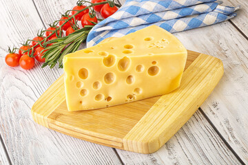 Maasdam cheese piece over board