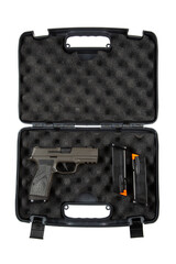 A black plastic case with foam padding contains a handgun and two magazines, showcasing a secure storage solution for firearms, isolated on a white back