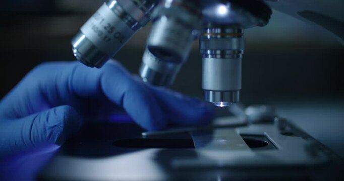 Scientist uses a microscope for research in hightech lab, demonstrating the complexity of their work