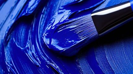 Paintbrush Coated in Vibrant Blue Paint on Textured Surface