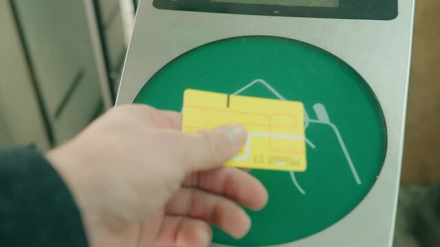 close-up of a hand using an RFID card to interact with a contactless payment terminal, showcasing security.