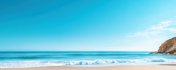 Obraz premium serene cliffside view of vast ocean horizon under soft blue sky. tranquil waves gently lap against sandy shore, creating peaceful atmosphere