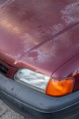 Faded clear coat on a red car, old clear coat fading away on paint