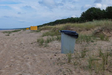 Plastic trash can on the east europe beach