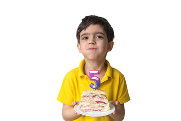 Portrait of happy five-year-old child with a birthday cake. Boy is blowing candles on homemade baked cake. Celebrate 5th Happy birthday. Party. Happy family concept, five years.