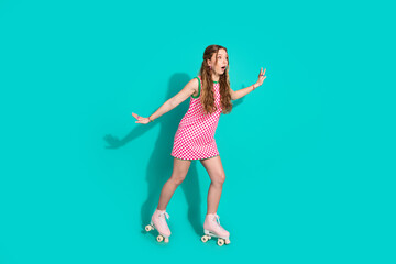 Full length photo of lovely teen lady ride roller skate scared dressed stylish pink plaid garment...