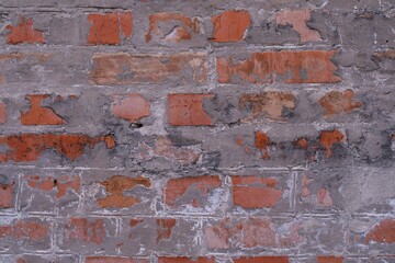 Red brick wall texture background. Brick wall with scratches and cracks. Background of old brick wall.