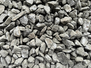 group of crushed stone close-up. rough seamless texture, construction material background, gravel. crusher stone, white pebbles, white stones. view on pebbles and stones on a gravel ground