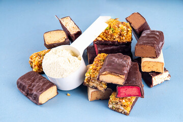 Set of various energy protein bar. Different taste of protein bars and snacks, with protein protein whey powder scoop