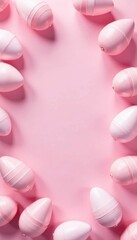 Fototapeta premium Pastel pink background with scattered pink & white Easter eggs forming a pleasing pattern , spring, whimsical, delicate