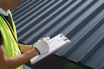 Worker, inspector, engineer is check and inspect roof house or building quality after roofing...