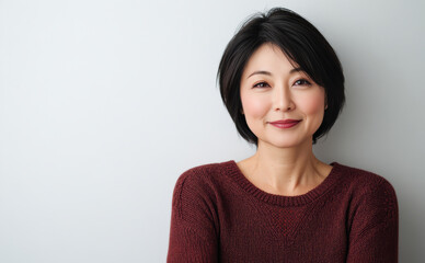 Obraz premium Middle-aged Asian women, in their late 30s to early 40s, pose in simple, everyday attire against clean white background. Portraits emphasize natural beauty casual, comfortable fashion.