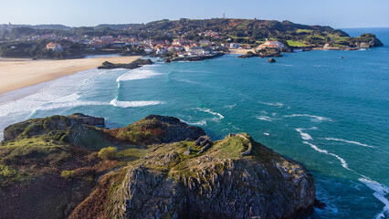 Rocky island, Cuarezo beach, Atlantic, the village of Isla. Cantabria, Spain.