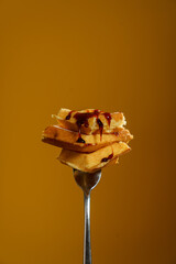 waffles on a fork with syrup
