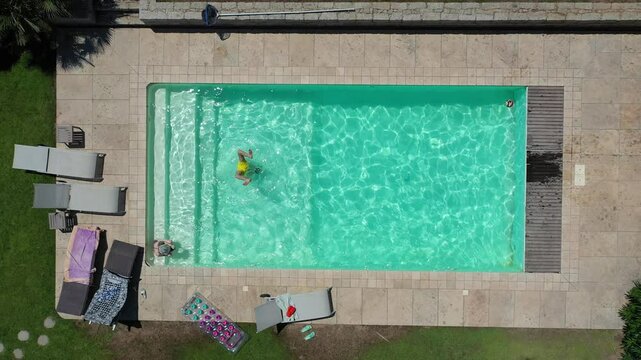 Top Shot d&rsquo;un drone au-dessus d&rsquo;une piscine avec une personne qui nage  
