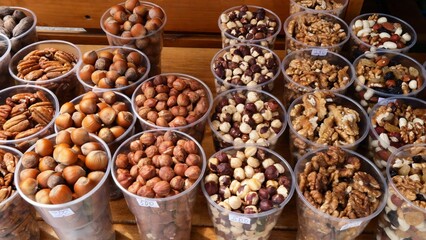 Fresh Nuts in Transparent Cups, Farme produce of organic healthy diet food. Market Grocery Shopping Display Close-Up
