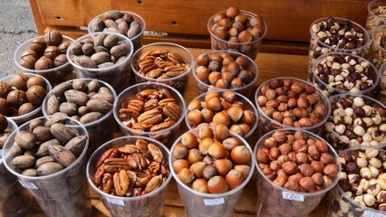 Fresh Nuts in Transparent Cups, Farme produce of organic healthy diet food. Market Grocery Shopping Display Close-Up