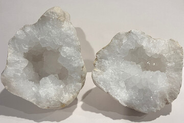 A stunning clear quartz crystal geode, expertly cut in half to reveal the dazzling interior of...