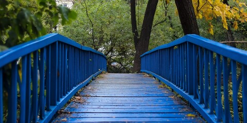 A vibrant blue bridge creates a stunning focal point connecting nature and tranquility in this serene park.