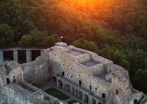 Neamt Fortress (Cetatea Neamtului in Romanian language). Aerial photo with a beautiful sunrise over this iconic fortress from Moldova, Romania. Travel to Romania history landmarks.