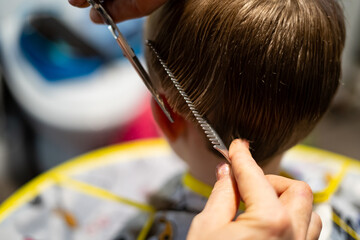 Blond Boy Getting a Haircut with Scissors and Clippers.