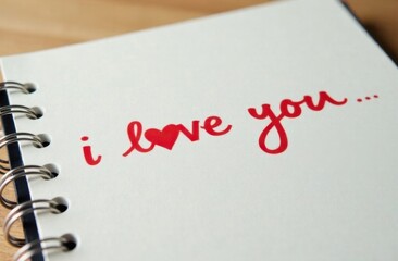 A handwritten inscription, the text "I love you" on a white sheet of paper, in a notebook or diary. A painted heart. A declaration of love. Romantic card for Valentine's Day, Mother's Day.