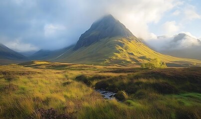 Misty mountain peak with a foreground stream.