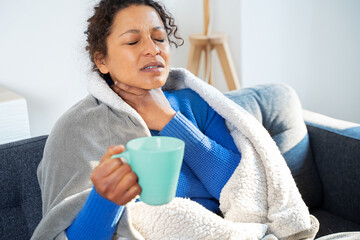 Portrait of black woman suffering tonsillitis at home