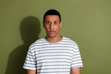Photo portrait of attractive young man serious look camera dressed stylish striped white clothes...