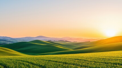Obraz premium A serene landscape featuring rolling green hills under a vibrant sunset, creating a tranquil and picturesque natural scene.