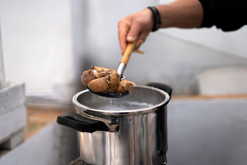close-up of a boy's hands cooking seafood on a terrace
