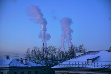 Thick white smoke is coming from the chimney of an industrial enterprise, the concept of air...