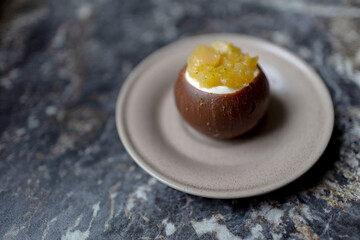 Cacos-shaped cake made of chocolate and passion fruit slices on a plate