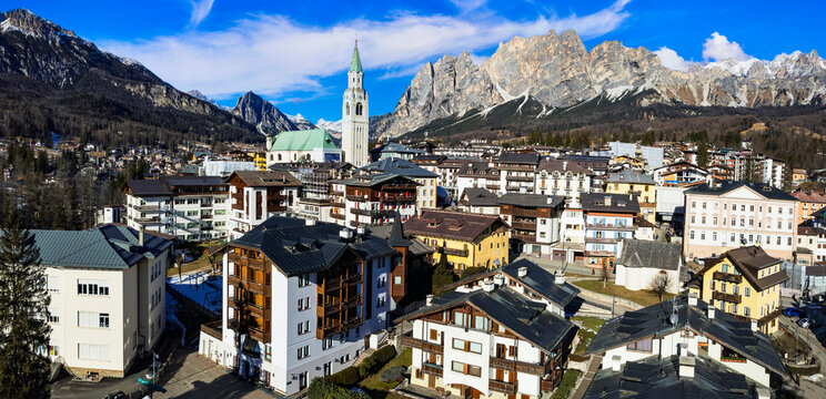 Panoramic Aerial View of Cortina d'Ampezzo Downtown at Winter &mdash; Famous Luxury Ski Resort in the Heart of Dolomites Alps, Belluno Veneto, Italy. Olympic 2026 Winter Destination