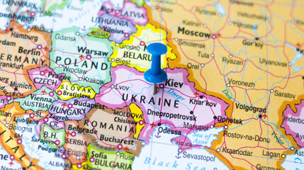 Ukraine country marked on geographical world map with push pin