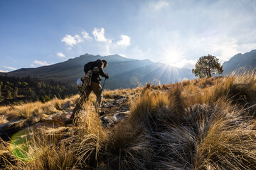 A mountaineer climbing a scenic volcano landscape