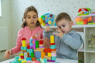 Children playing with toys in the room. Selective focus