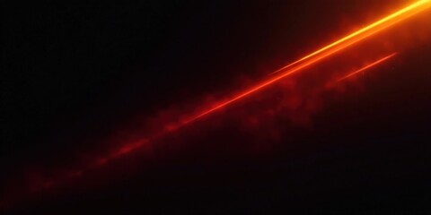 Fototapeta premium Dynamic Orange Streak Across Dark Background, Ideal for Abstract Designs and Visual Effects
