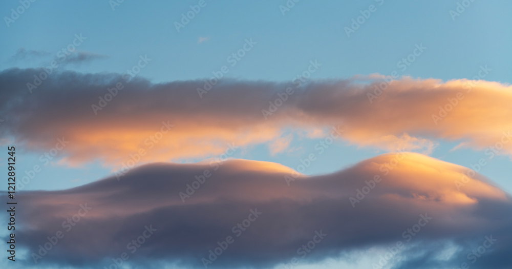 Wall mural beautiful orange sunset clouds on the blue sky. sky background.