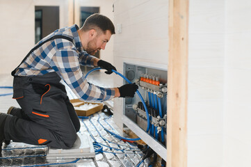 Water underfloor heating systems installation, work in progress on construction site for a modular...