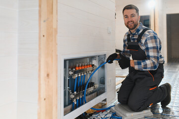 Water underfloor heating systems installation, work in progress on construction site for a modular...