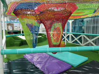 Multi-colored grids elongated in the form of a cone in the playroom for children's games and...