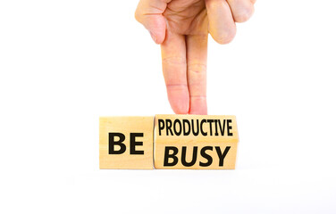Be productive not busy symbol. Concept words Be productive Be busy on wooden block. Beautiful white table white background. Businessman hand. Business be productive not busy concept. Copy space.
