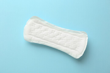Menstrual pad on light blue background, top view