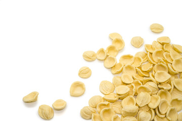 Orecchiette pasta scattered on white