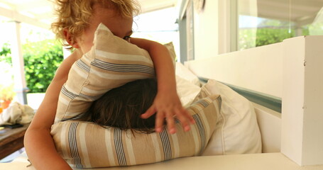 Children playing with pillow at home