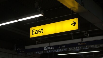 Vibrant East sign with arrow at train station