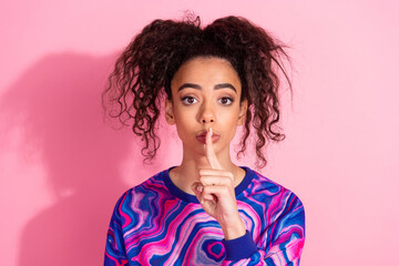 Photo of charming strict woman wear print sweatshirt finger mouth empty space isolated pink color...