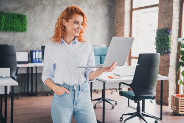 Obraz premium Portrait of young corporate worker lady use laptop spacious modern loft interior business center indoors