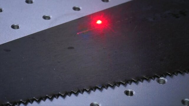 Metal Surface Laser Engraving Close-Up with Red Beam